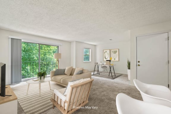 a living room with white walls and a large sliding glass door leading to a balcony at Beacon Hill and Great Oaks Apartments, Rockford
