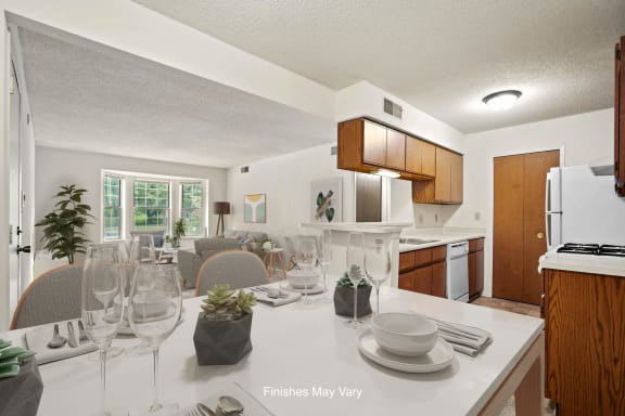 a kitchen and living room with a dining table and chairs at Beacon Hill and Great Oaks Apartments, Rockford, IL, 61109