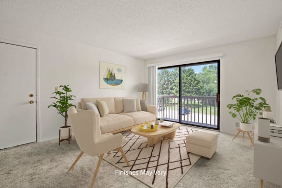 a living room with a white couch and a sliding glass door leading to a balcony at Beacon Hill and Great Oaks Apartments, Rockford, 61109