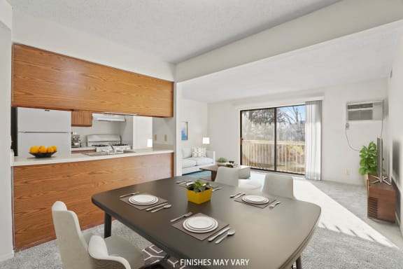 a dining area with a table and chairs and a kitchen in the background at Beacon Hill and Great Oaks Apartments, Rockford, Illinois