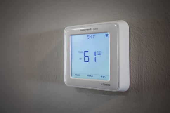 a white thermostat sitting on top of a white wall at Rivers Edge Apartments, Waterford Twp, MI