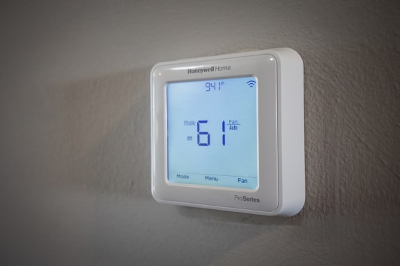 a white thermostat sitting on top of a white wall at Eastgate Woods Apartments, Batavia, OH, 45103
