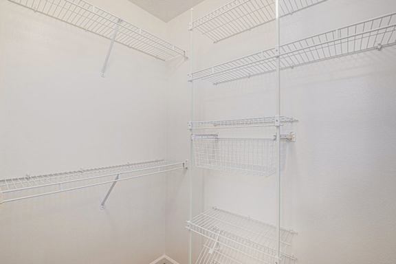 A walk in closet with wardrobe organizers at Black Sand Apartment Homes, Lincoln, Nebraska
