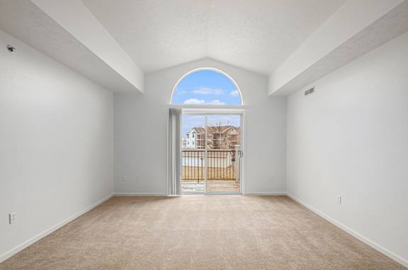 A spacious living room with a view of a balcony at Black Sand Apartment Homes, Lincoln, Nebraska