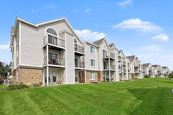 Apartment buildings with patios and balconies and green lawns at Black Sand Apartment Homes in Lincoln, NE