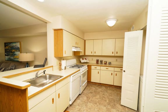 a kitchen with white cabinets and a sink at Brentwood Park Apartments, La Vista, NE, 68128