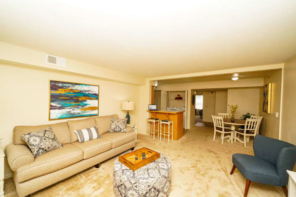 a living room with a couch and a table at Brentwood Park Apartments, La Vista, 68128