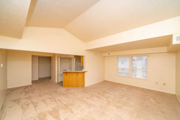 the living room and kitchen of an empty house with a counter at Brentwood Park Apartments, La Vista, 68128