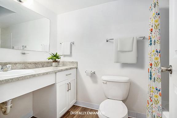 An upgraded bathroom with a toilet next to a white sink An upgraded bathroom with a toilet next to a white sink at Brentwood Park Apartments, La Vista, 68128