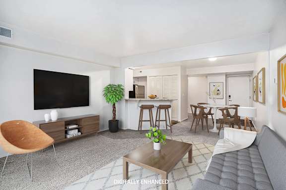 A modern living room with a grey sofa, a coffee table, and plush carpeting A modern living room with a grey sofa, a coffee table, and plush carpeting at Brentwood Park Apartments, La Vista, 68128