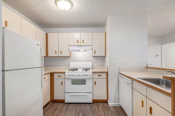 A kitchen with a breakfast bar at Brentwood Park Apartments in LaVista, NE