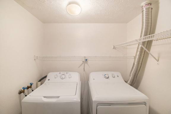 A laundry room with a full size washer and dryer at Brentwood Park Apartments in LaVista, NE