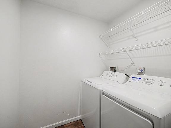 A laundry room with a full size washer and dryer at Brentwood Park Apartments in LaVista, NE