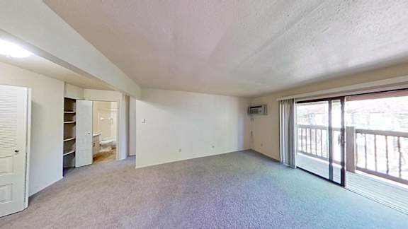 A spacious living room with a balcony A spacious living room with a balcony at Briarwood Apartments in Benton Harbor, MI