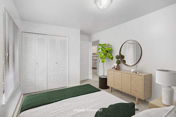 a bedroom with a bed and a window a bedroom with a bed and a window at Briarwood Apartments, Michigan