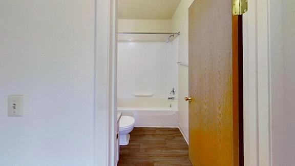 A bathroom with a toilet, tub, and sink A bathroom with a toilet, tub, and sink at Briarwood Apartments in Benton Harbor, MI