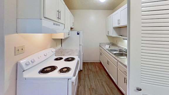 A kitchen with white cabinets and appliances A kitchen with white cabinets and appliances at Briarwood Apartments in Benton Harbor, MI
