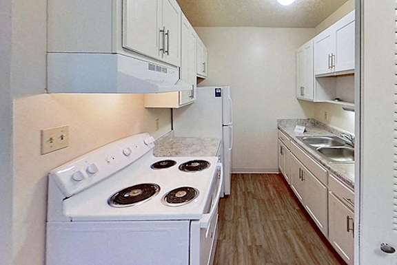 a kitchen with a sink and a refrigerator at Briarwood Apartments, Benton Harbor, 49022