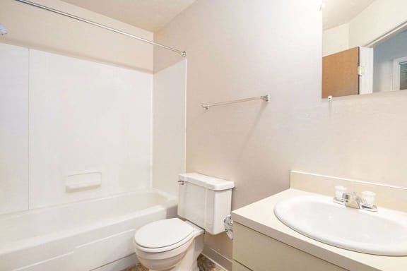 A bathroom with a bathtub and shower A bathroom with a bathtub and shower at Brookside Apartments, Springfield