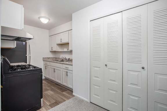 A kitchen with white cabinets and stainless steel appliances at Brookside Apartments, Springfield