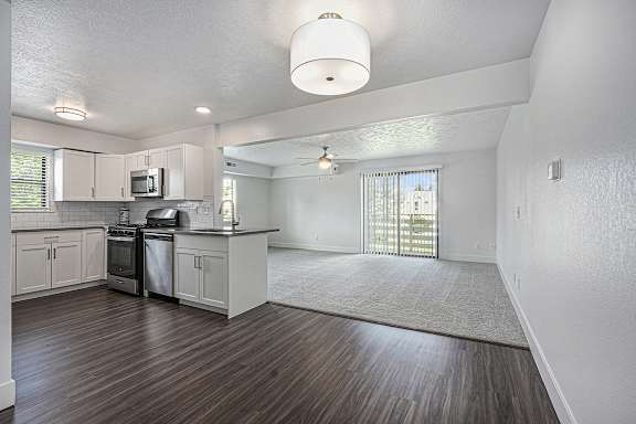 A kitchen with white cabinets and a hard surface floor A kitchen with white cabinets and a hard surface floor at Byron Lakes Apartments, Michigan, 49315