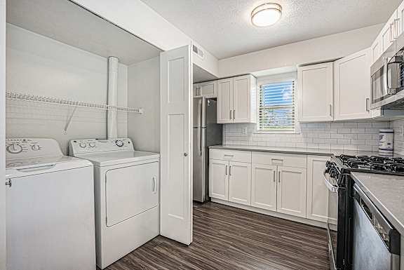 A kitchen with a washer and dryer A kitchen with a washer and dryer at Byron Lakes Apartments, Michigan, 49315