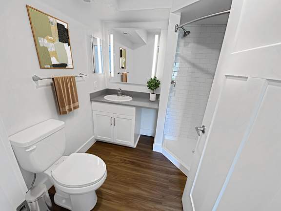 A second bathroom with a toilet, sink, mirror and shower at Byron Lakes Apartments, Michigan, 49315