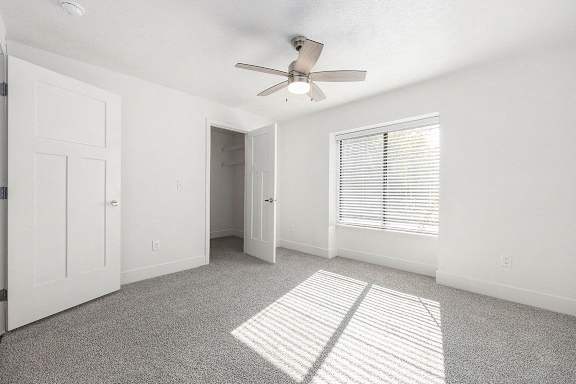 Spacious Bedroom with Ceiling Fan at Byron Lakes Apartments, Michigan, 49315