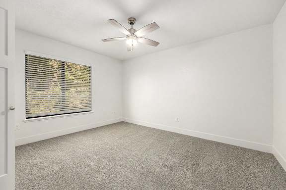 bedroom with a large window at Byron Lakes Apartments, Byron Center, Michigan