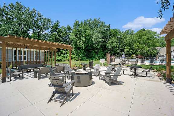 A fire pit and chairs at Byron Lakes Apartments in Byron Center, MI