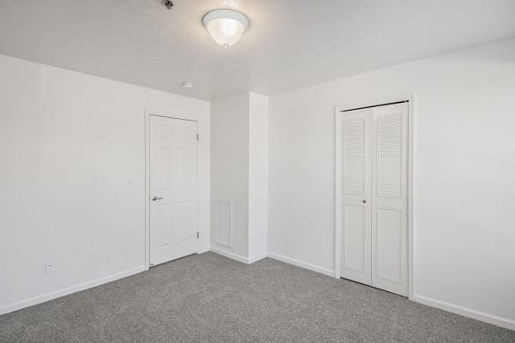 Spacious bedroom with a walk in closet Spacious bedroom with a walk in closet at Canal 2 Apartments in Lansing, MI