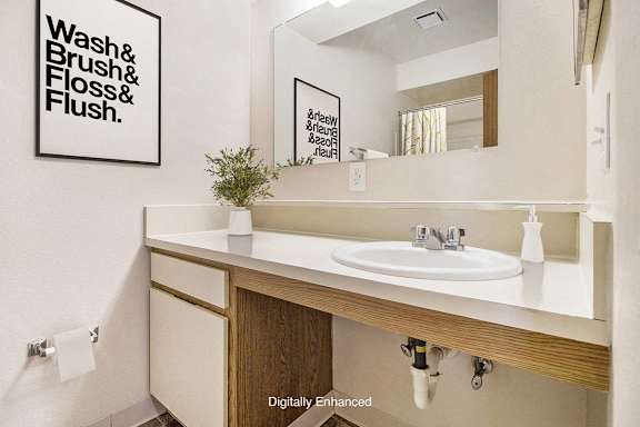 A bathroom with a large vanity at Canal Club Apartments, Lansing, 48917