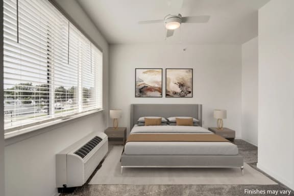 a bedroom with white walls and a large window with blinds  at Uptown Square Apartments, Troy, MI, 48083