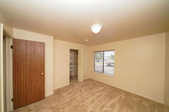 A large bedroom with a walk in closet at Canal Club Apartments, Lansing