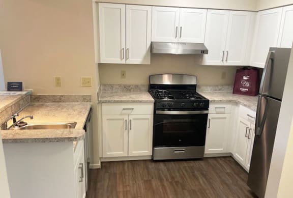 Renovated Kitchen with Breakfast Bar at Canal Club Apartments in Lansing, Michigan