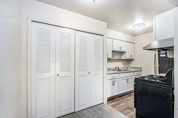 An upgraded kitchen with white cabinets and stainless steel appliances at Concord Place Apartments, Kalamazoo, MI