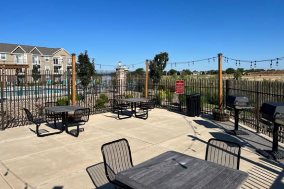 Grilling Area with Tables at Copper Creek Apartment Homes in Maize, KS