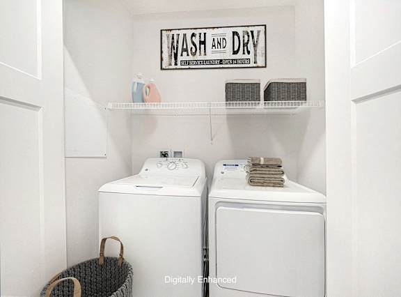 A laundry area with a full size washer and dryer at Copper Creek Apartment Homes, Kansas, 67101