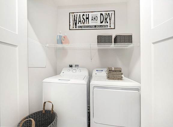 A laundry area with a full size washer and dryer at Copper Creek Apartment Homes, Kansas, 67101