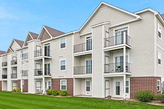 Three story apartment building with balconies at Copper Creek Homes Apartments, Maize, Kansas