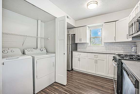 A kitchen with a washer and dryer at The Crossings Apartments in Grand Rapids, MI