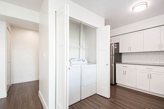 A laundry room with a full-size washer and dryer at The Crossings Apartments, Grand Rapids