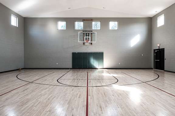 an empty gym with a basketball court and wood floors at Latitudes Apartments, Indianapolis