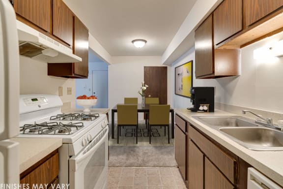 a kitchen with a stove top oven next to a sink at Beacon Hill and Great Oaks Apartments, Rockford, IL, 61109