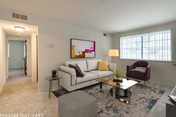 a living room with a white couch and a coffee table at Beacon Hill and Great Oaks Apartments, Illinois