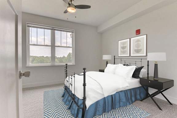 A bedroom with a bed, nightstand, and a large window at Dodson Pointe Apartment Homes, Rogers, AR