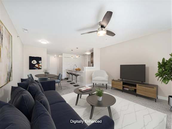 A living room with a sofa and a ceiling fan at Dodson Pointe Apartment Homes, Rogers