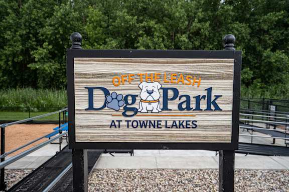 A sign for Off the Leash Dog Park at Towne Lakes