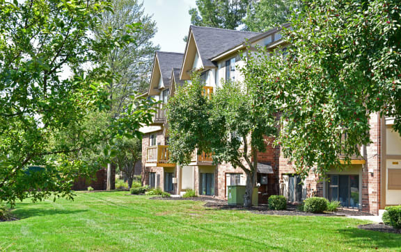 a group of houses with trees in front of themat Woodland Place, Michigan, 48640
