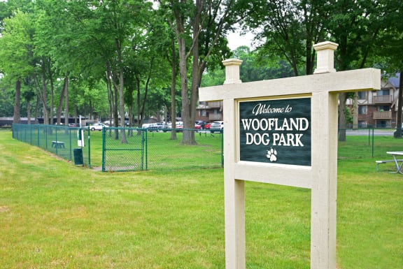 a dog park with a sign that says welcome to woodland dog parkat Woodland Place, Michigan